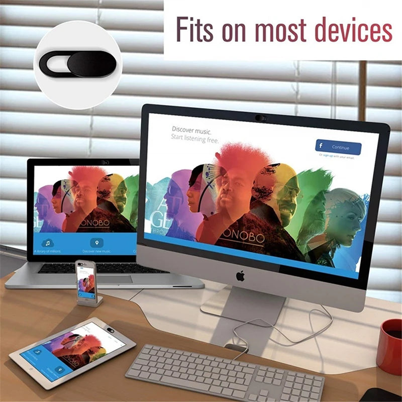 Multimedia device on a desk with computer, laptop, tablet, and smartphone displaying a colorful interface.