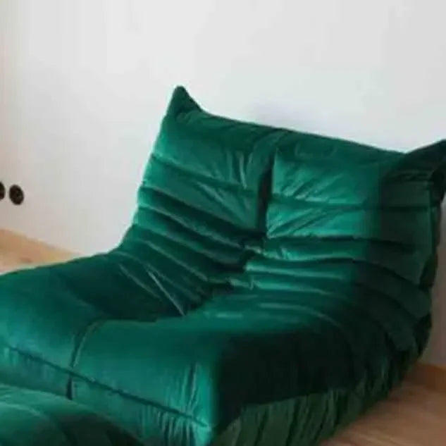 Green bean bag chair on a wooden floor against a white wall
