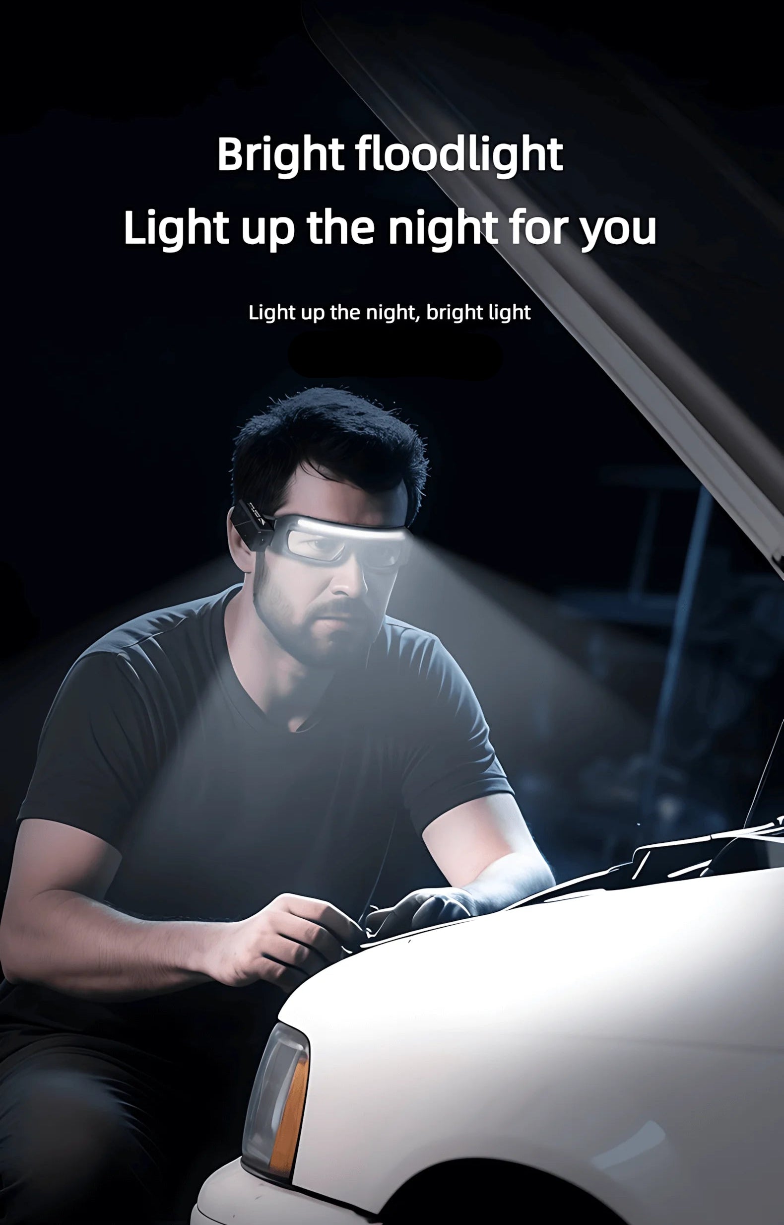 Person working on a car with a bright floodlight illuminating the area.