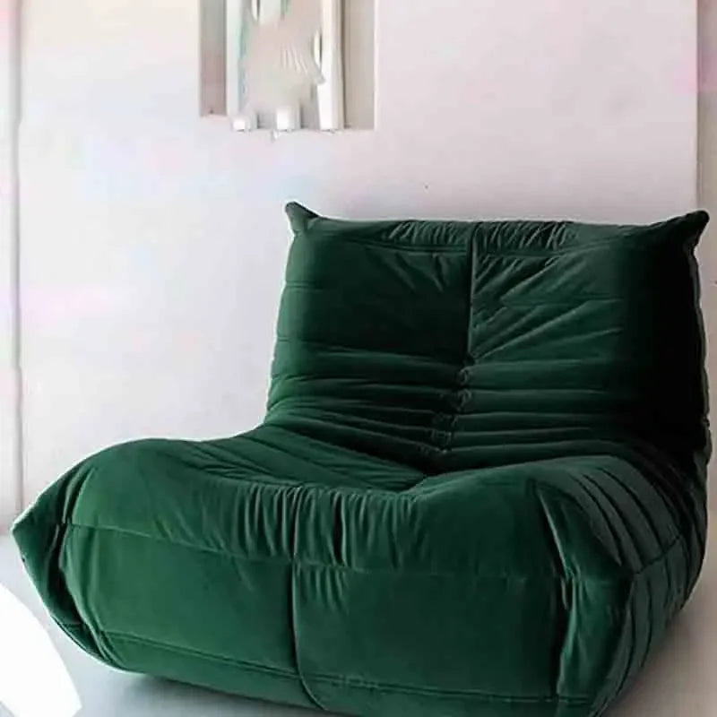 Green bean bag chair against a white wall