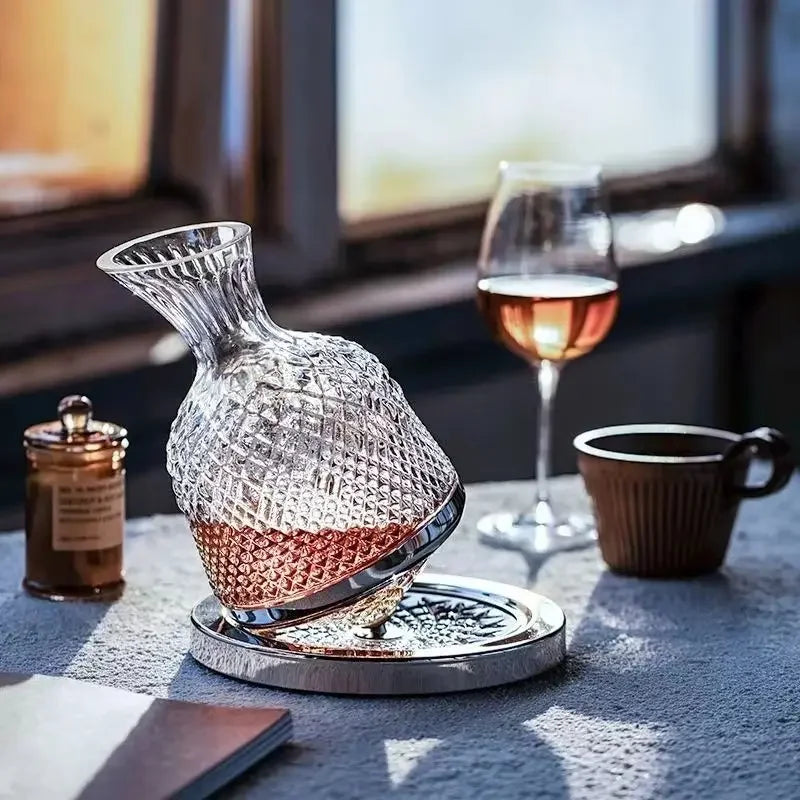 Crystal decanter with wine on a table with a glass and cup in the background