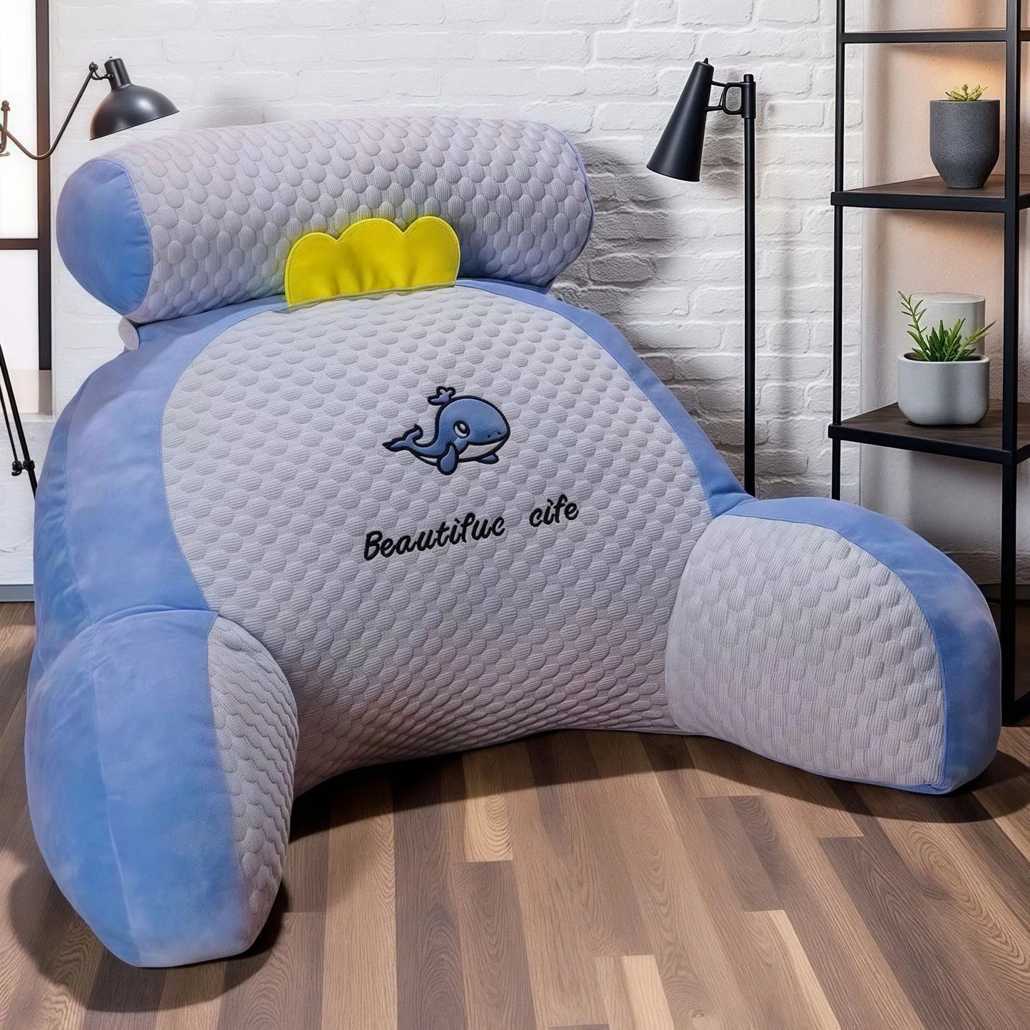Blue and gray backrest pillow with a whale design and 'Beautiful life' text on a wooden floor.