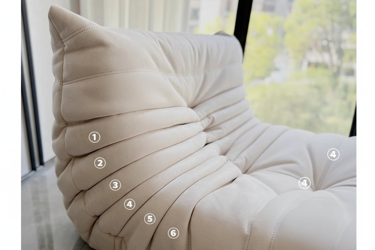 Beige pillow with pleated texture and labeled layers on a blurred indoor background