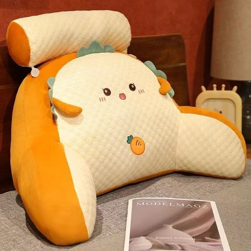 Cute cartoonish pillow with orange and beige colors on a surface.