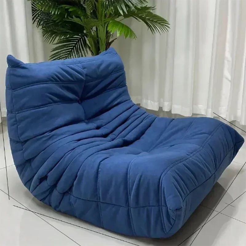 Blue bean bag chair on a tiled floor with a plant in the background