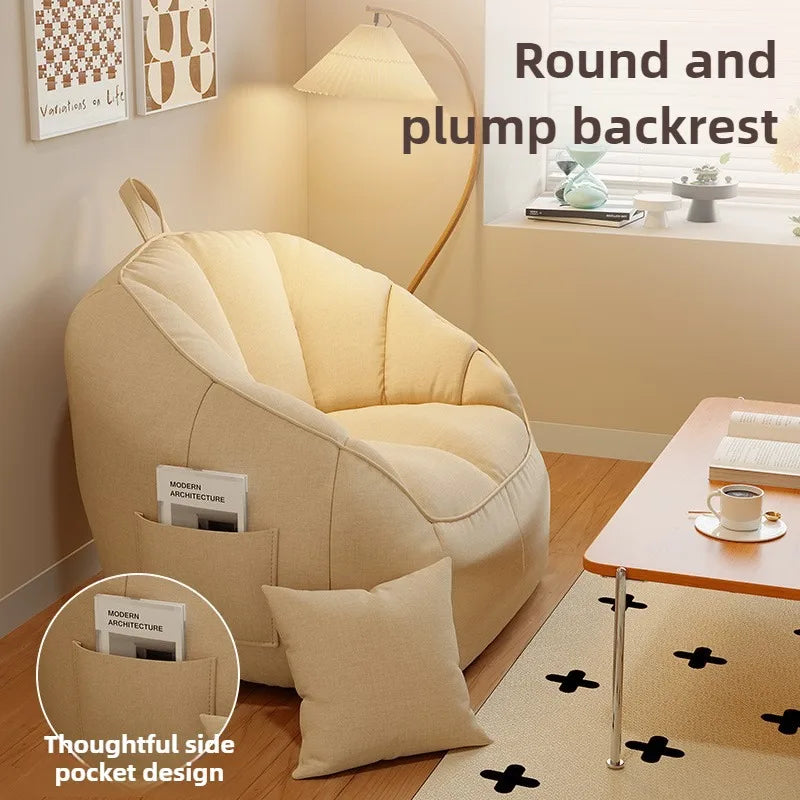 Beige bean bag chair with round and plump backrest in a room setting.
