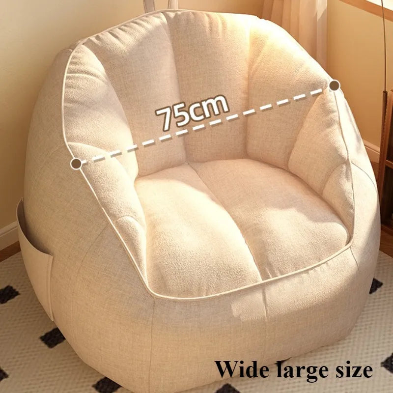Beige bean bag chair with dimensions indicating a wide large size.